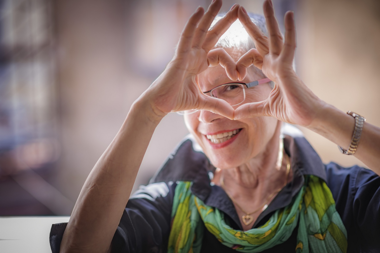 Woman forming heart with hands